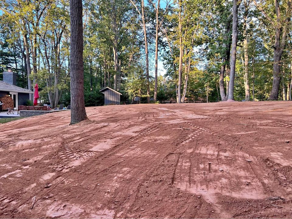 Grading a yard to direct the water away from the property